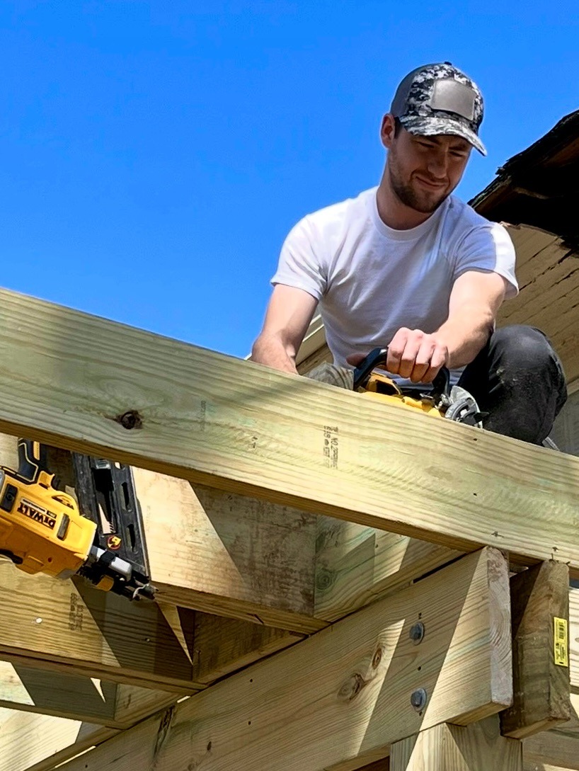 BidWise founder working on timber framing at a construction site